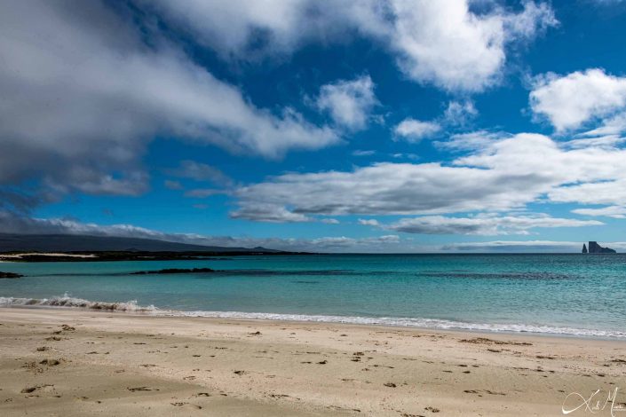 Beautiful scenic photo of a beach in Galapagos with golden sand and turquoise blue waters