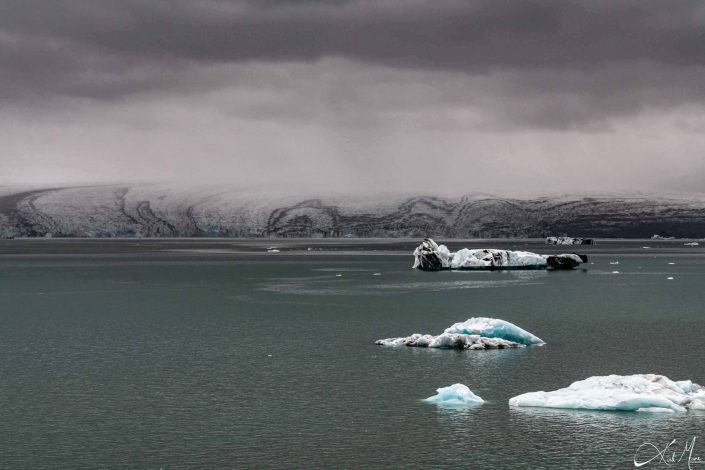 Beautiful photo of a glacier with icebergs in front of it