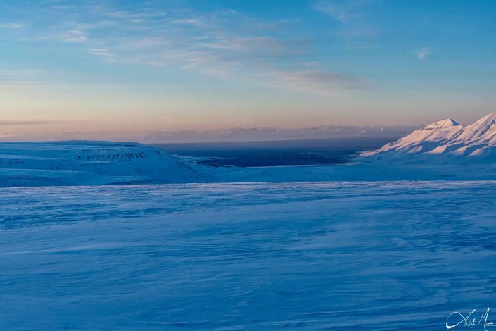 Best scenic sunset photo of snow covered mountains in Longyearbyen