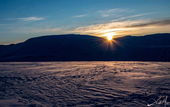 Best scenic sunset photo of snow covered mountains in Longyearbyen