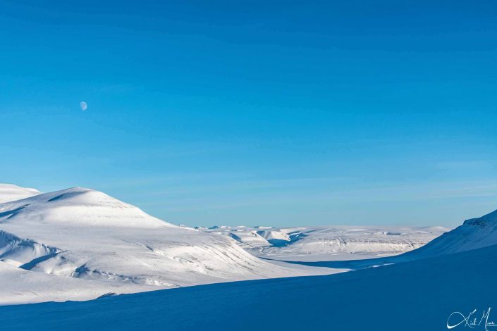 Best scenic photo of snow-covered mountains with clear blue sky and moon