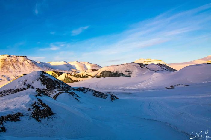 Scenic photo of snow covered mountains with clear blue sky