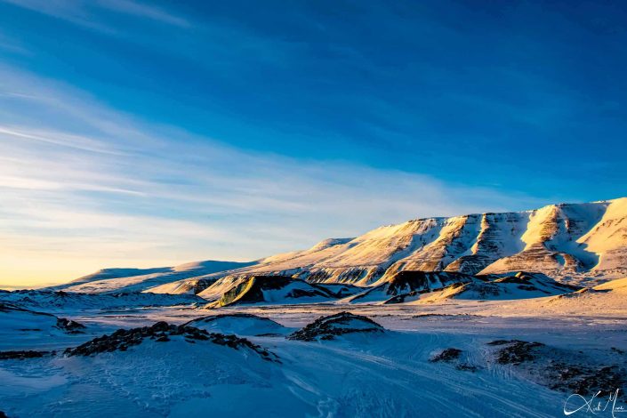 Scenic photo of snow covered mountains with clear blue sky