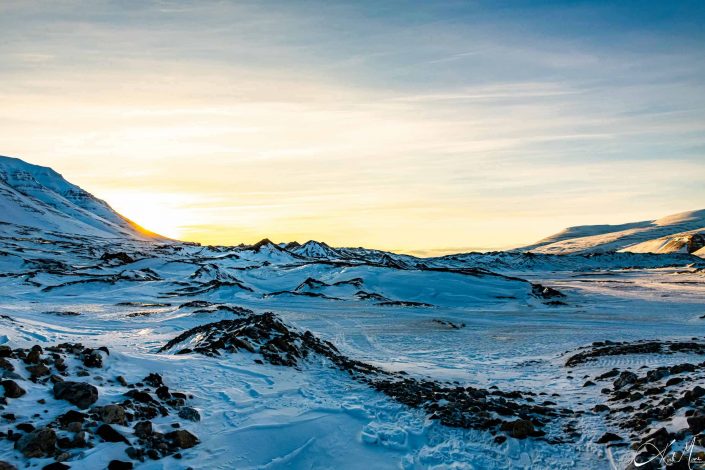 Scenic photo of snow covered mountains with sun light filtering in