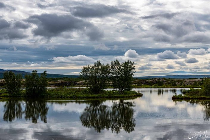 Best photo of a scenic landscape with dramatic sky and reflection of the trees in the water