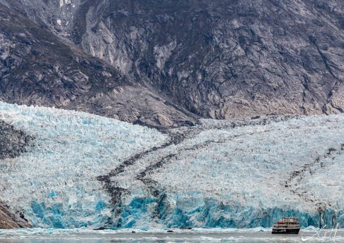 Close-up of a glacier along with a ship close to it