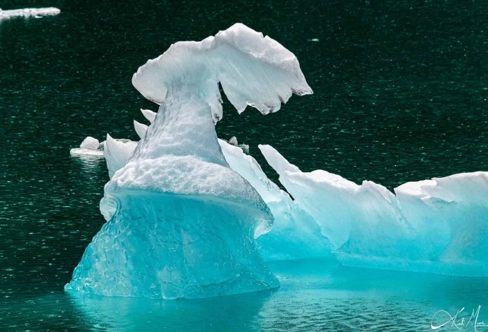 Beautiful photo of an small iceberg, which looks like a conical artistic sculpture