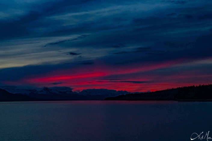 Beautiful sunset with dark shades of blue and pink with snow-capped mountains