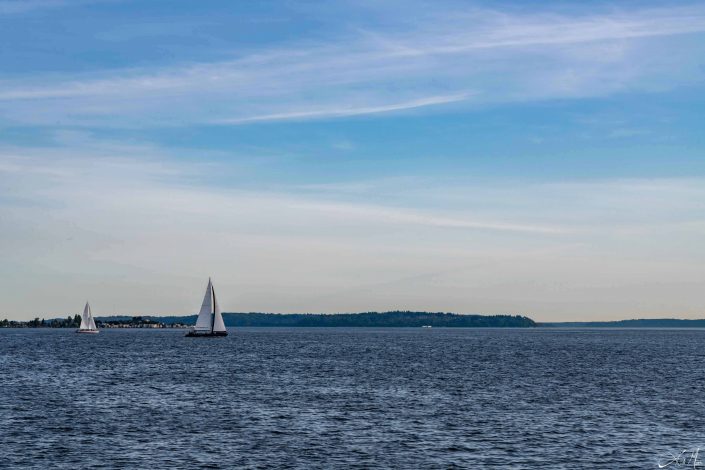 Beautiful photo of a boat sailing in blue waters and brilliant blue sky above