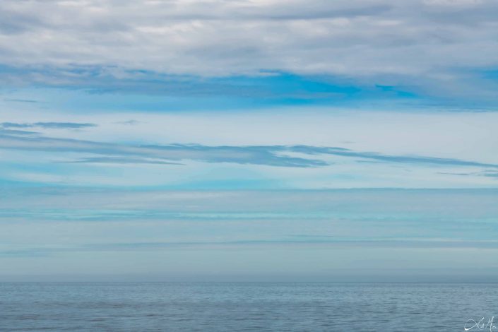 Beautiful photo of shades of blue starting from the sky and ending in the water beneath, blending in perfectly