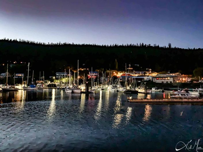 Beautiful photo of reflection of boats and lights at the harbour in the evening